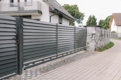 Photo of Metal gates near marble columns and house outdoors