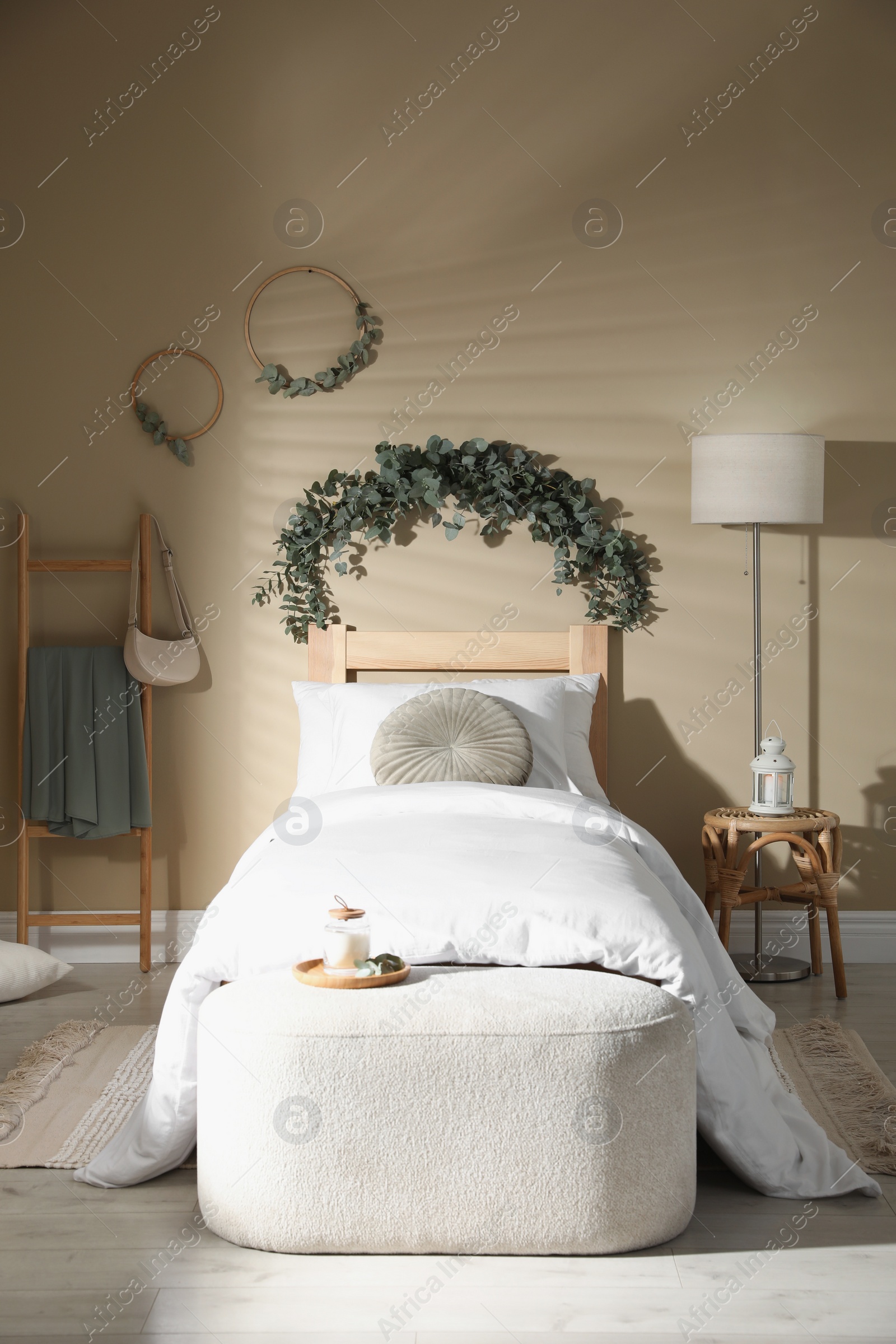 Photo of Stylish bedroom decorated with beautiful eucalyptus garland