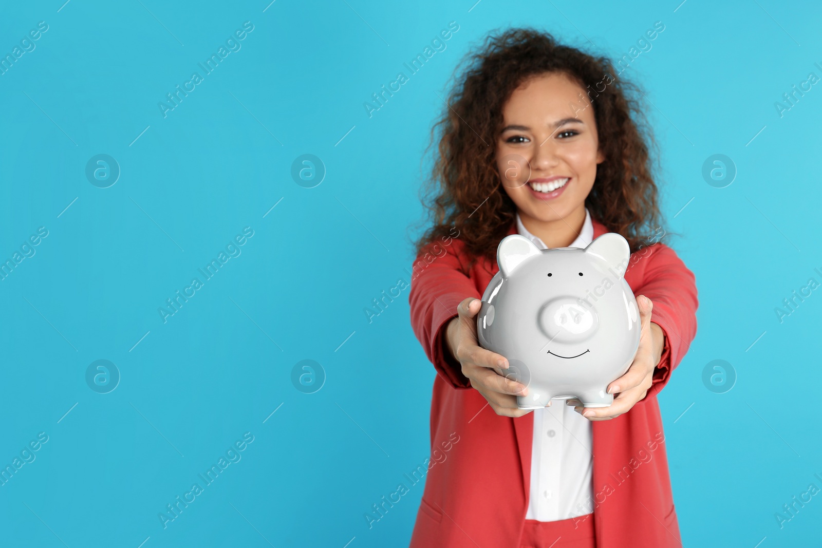Photo of African-American businesswoman with piggy bank on color background, space for text. Money saving