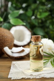 Bottle of organic coconut cooking oil on wooden table