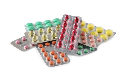 Blisters with different pills on white background