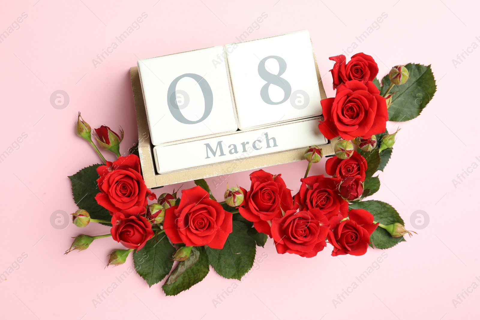 Photo of Wooden block calendar with date 8th of March and roses on pink background, flat lay. International Women's Day