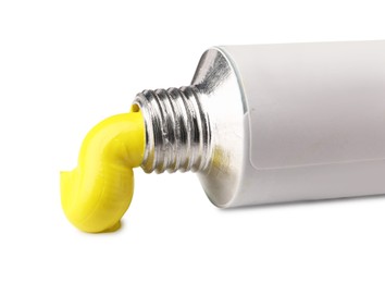 Photo of Tube with yellow oil paint on white background
