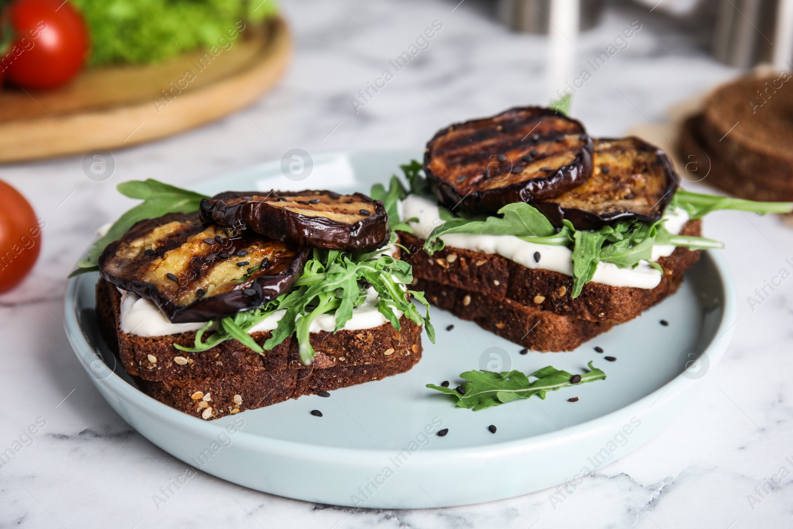 Photo of Delicious eggplant sandwiches served on white marble table