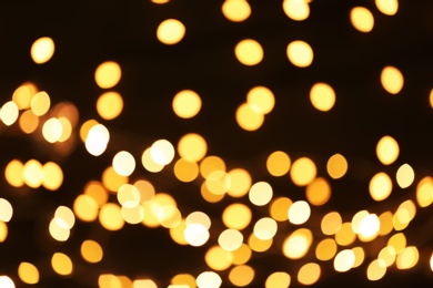 Beautiful golden lights on dark background. Bokeh effect