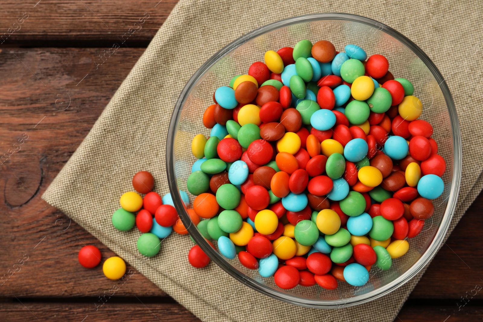 Photo of Tasty colorful candies on wooden table, flat lay