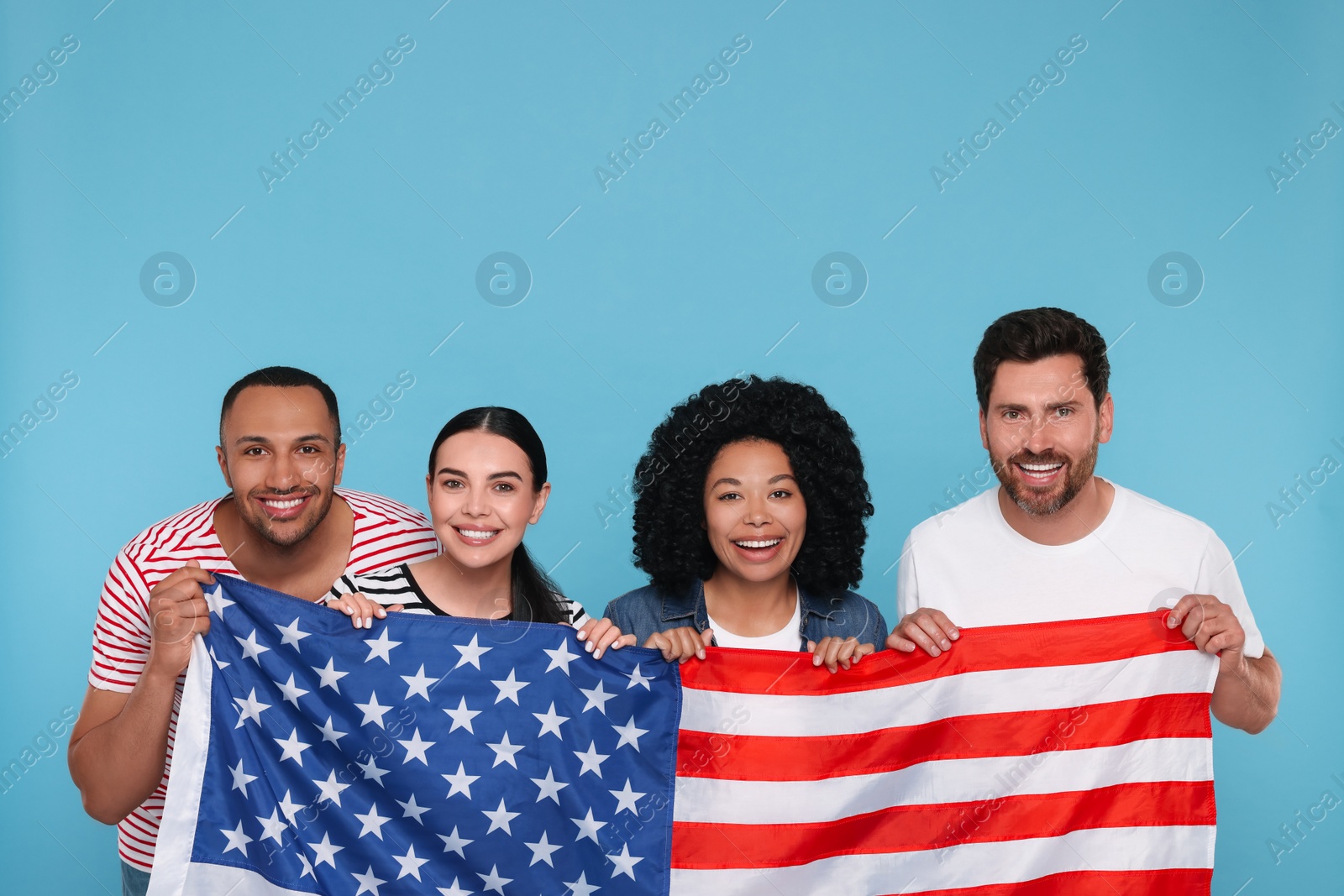 Photo of 4th of July - Independence Day of USA. Happy friends with American flag on light blue background