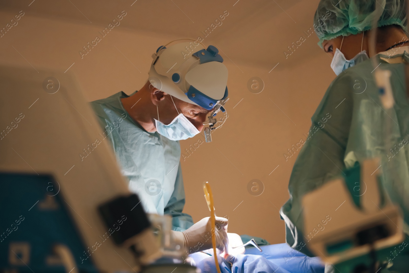 Photo of Professional doctors performing operation in surgery room