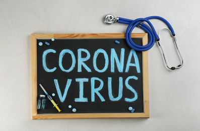 Photo of Chalkboard with words CORONA VIRUS and stethoscope on light background, flat lay