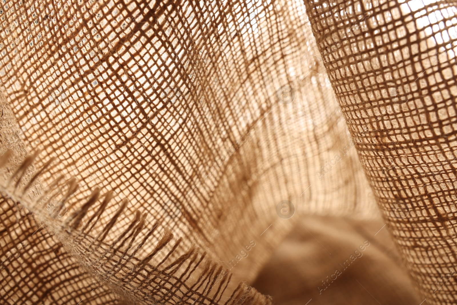 Photo of Texture of natural burlap fabric as background, closeup