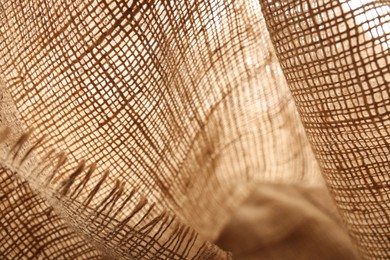 Photo of Texture of natural burlap fabric as background, closeup