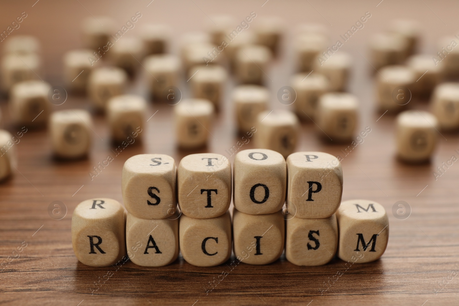 Photo of Cubes with phrase Stop Racism on wooden table