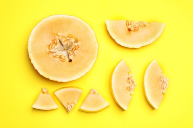 Photo of Flat lay composition with tasty melon on yellow background