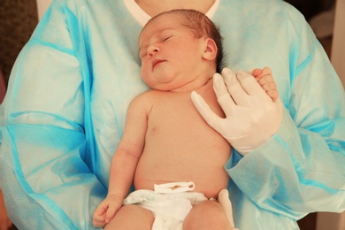 Photo of Doctor holding cute newborn child in hospital