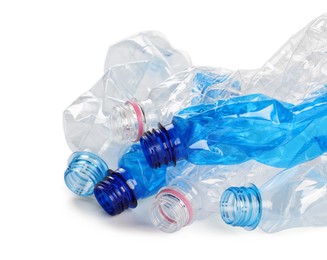 Photo of Crumpled disposable plastic bottles on white background, space for text