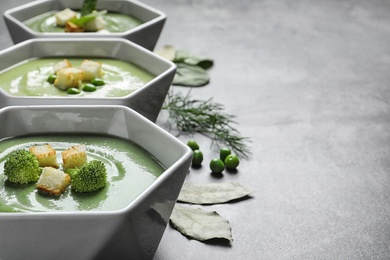 Photo of Fresh vegetable detox soup made of broccoli with croutons on table. Space for text