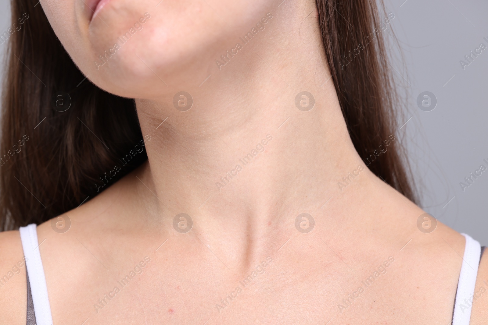 Photo of Closeup view of woman with normal skin on grey background