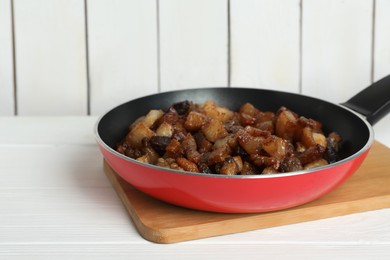 Photo of Tasty fried cracklings on white wooden table. Cooked pork lard