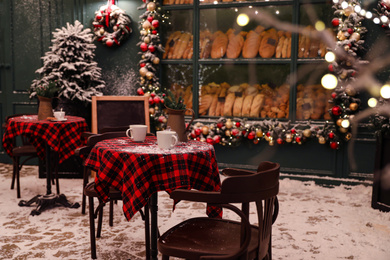 Photo of Beautiful outdoor cafe with festive decoration. Christmas celebration