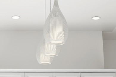 Photo of White modern lighting on ceiling in room