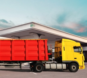 Bright truck driving to modern gas filling station