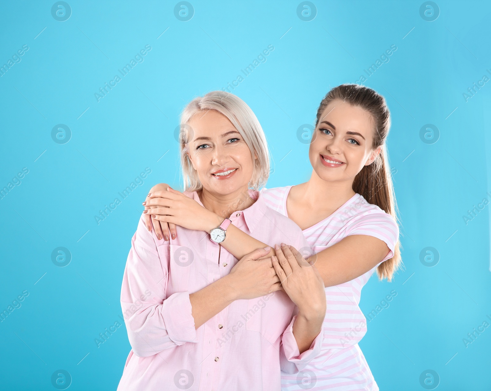 Photo of Portrait of young woman with her mature mother on color background