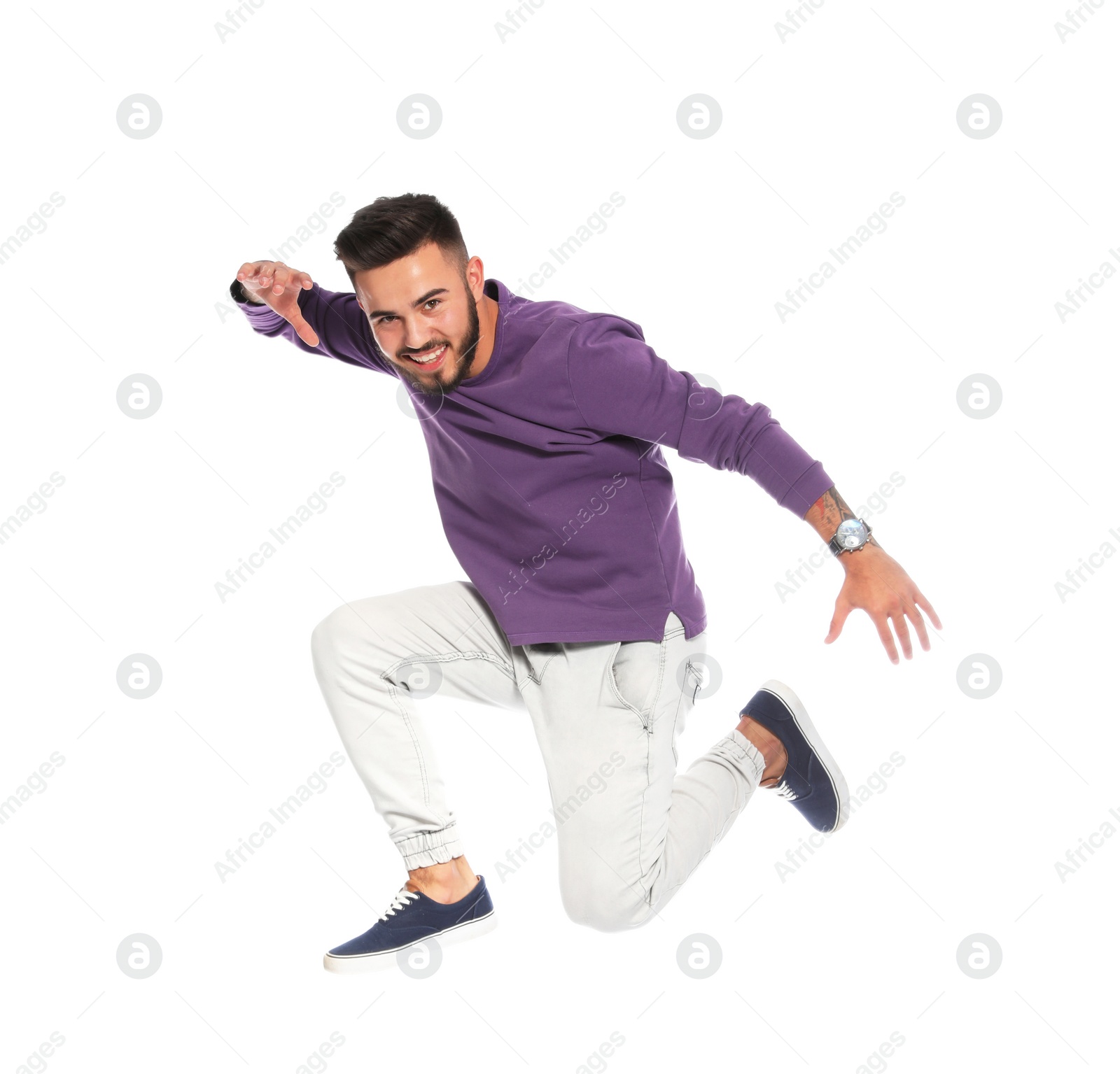 Photo of Handsome young man jumping on white background