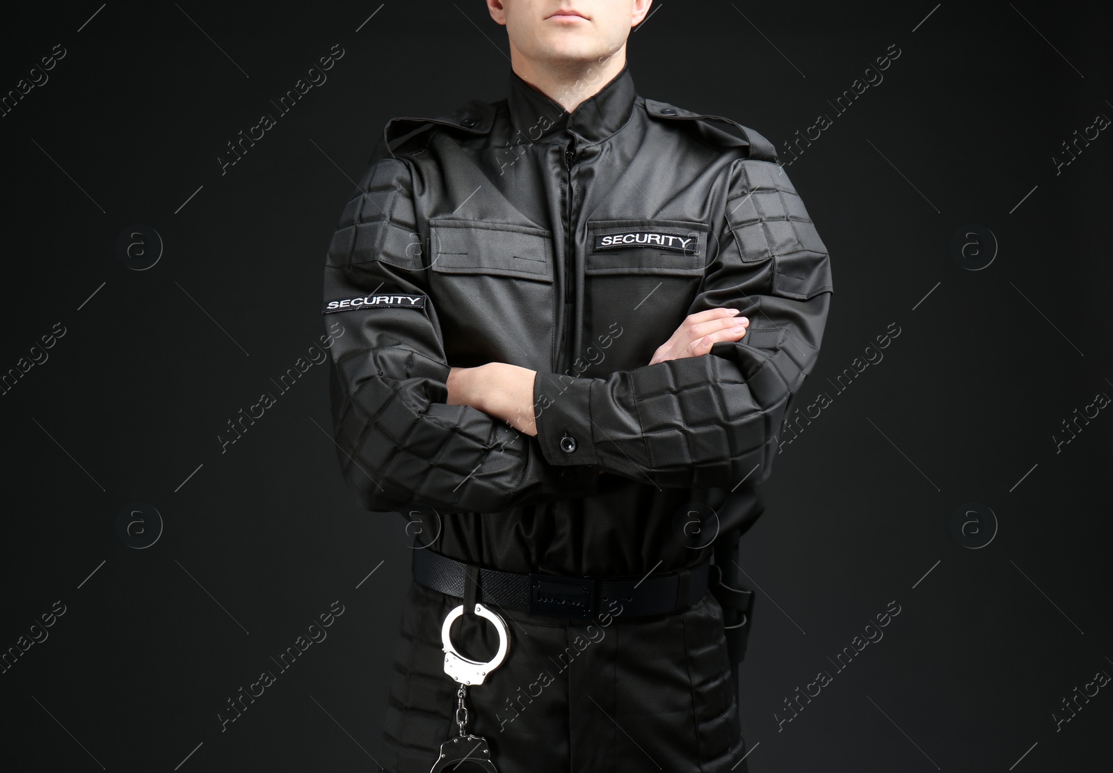 Photo of Male security guard in uniform on dark background