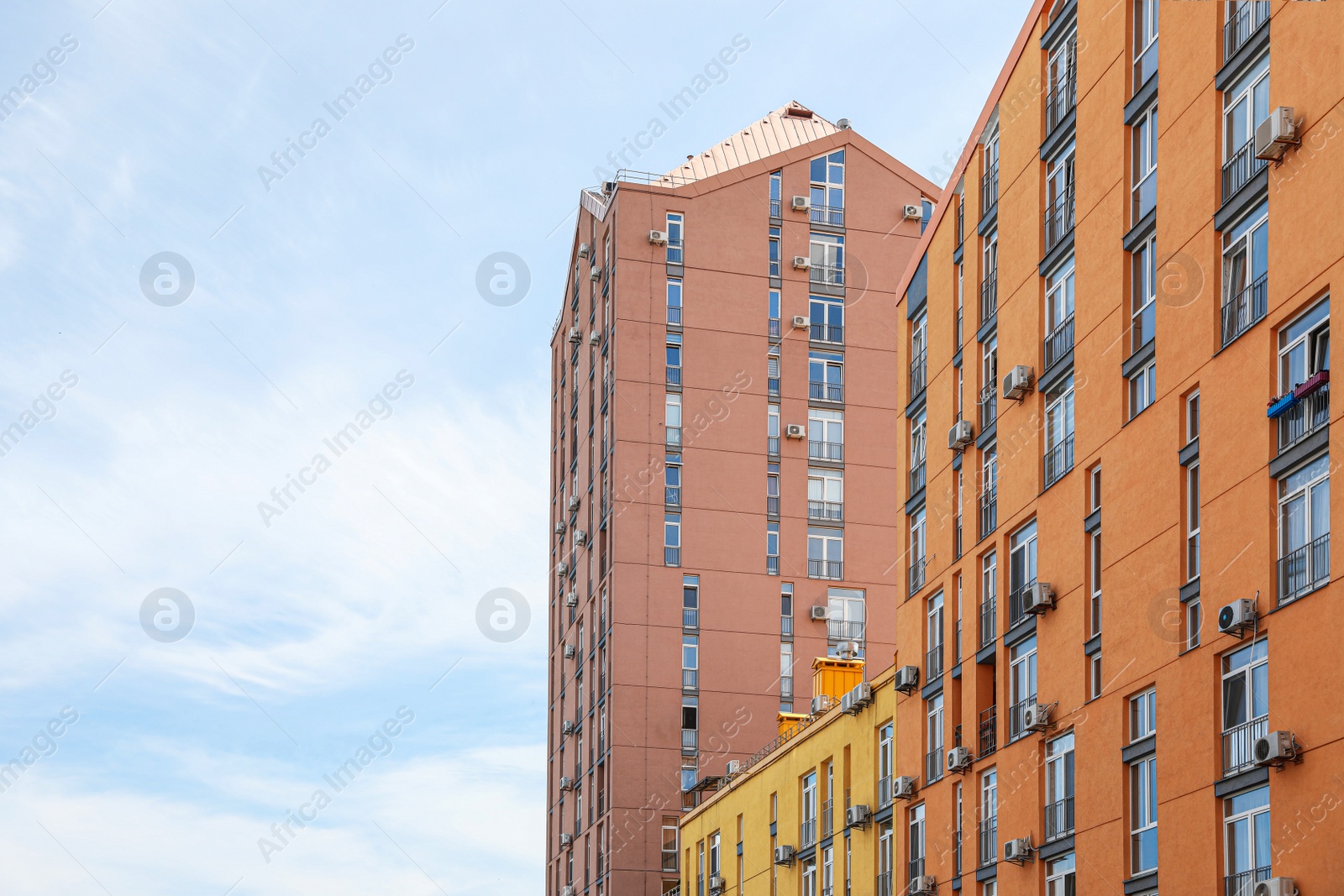 Photo of Modern buildings with windows against sky. Urban architecture