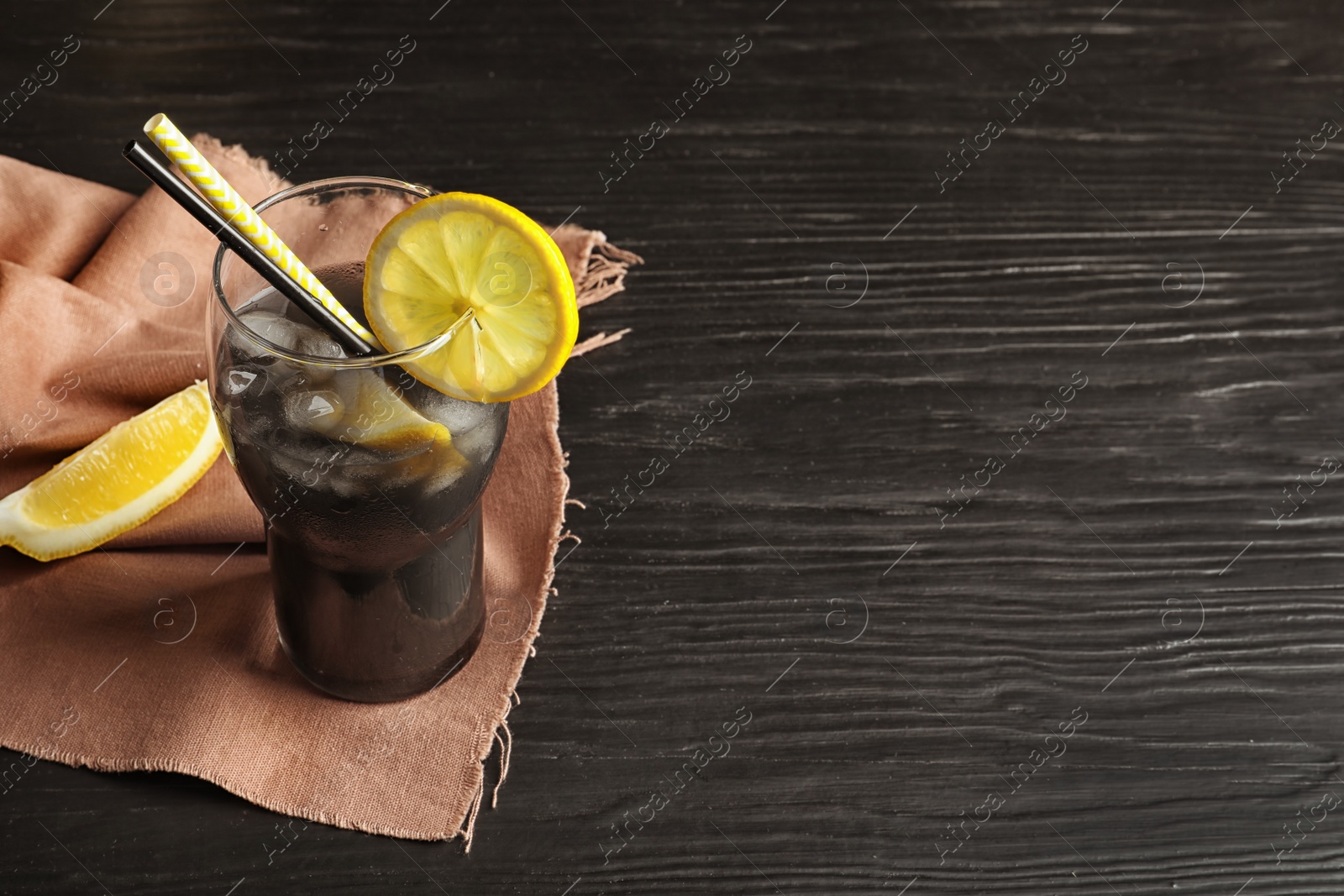 Photo of Glass with natural black lemonade on table