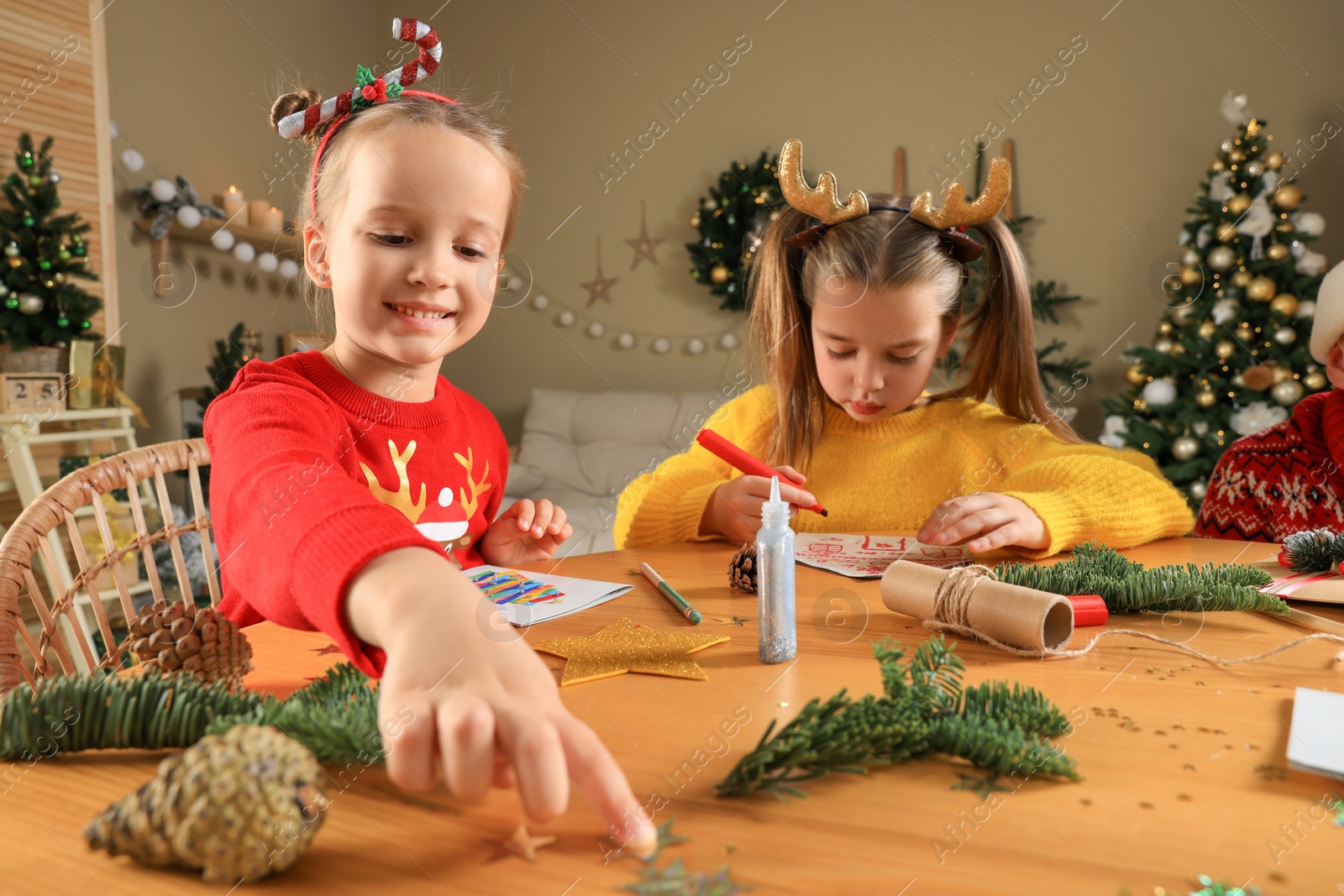 Photo of Cute little children making beautiful Christmas greeting cards at home