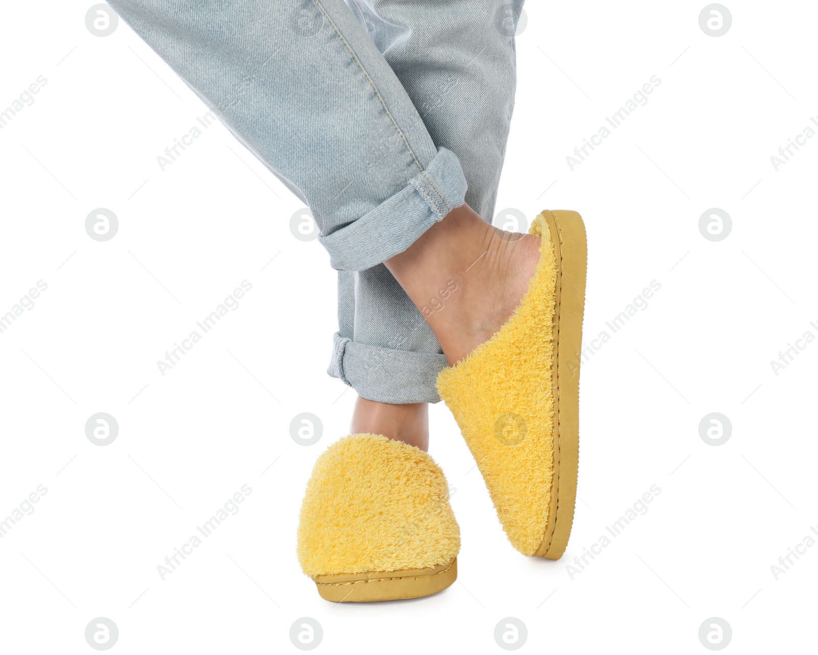 Photo of Woman in yellow soft slippers on white background, closeup