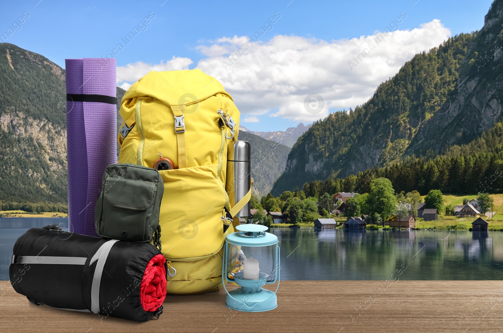 Image of Camping equipment for tourist on wooden surface and beautiful view of mountain landscape