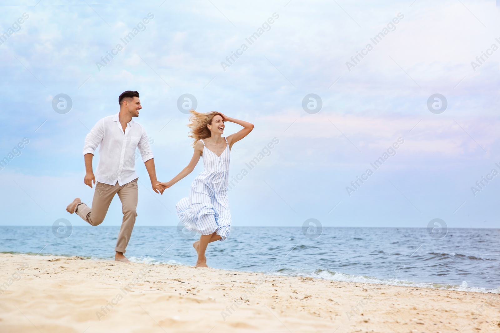 Photo of Happy couple running on beach, space for text. Romantic walk