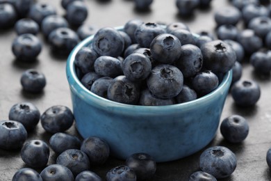 Tasty fresh blueberries on grey table, closeup