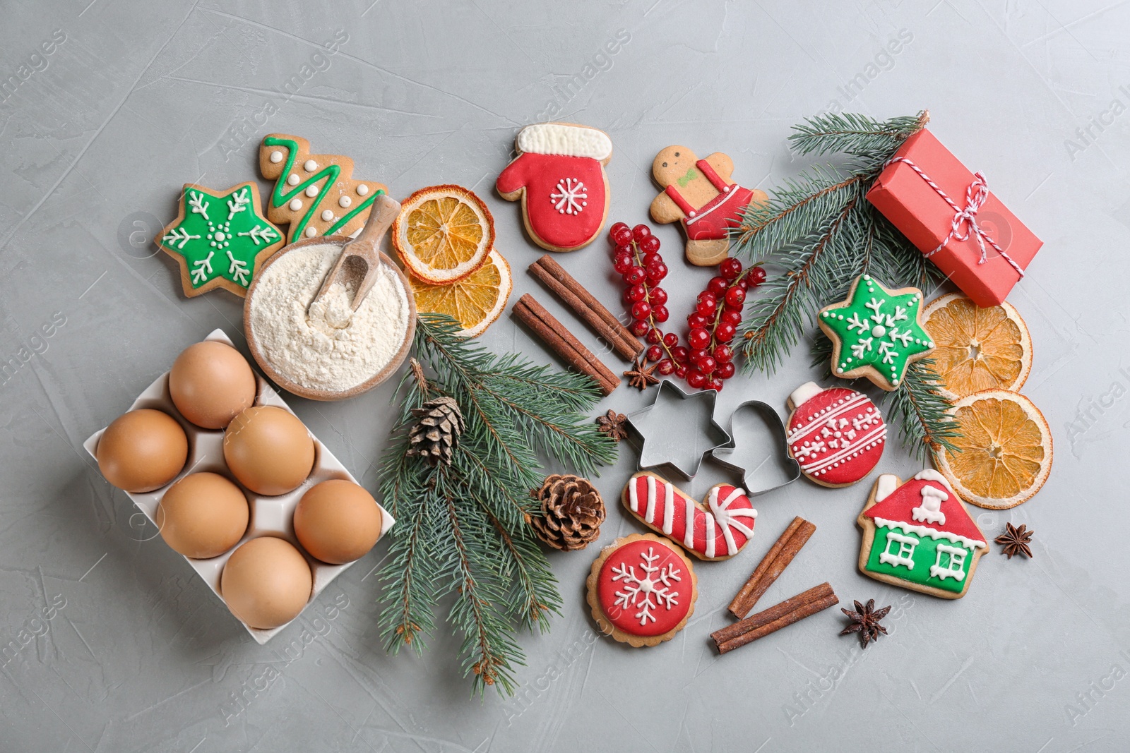 Photo of Flat lay composition with homemade Christmas cookies and ingredients on grey background