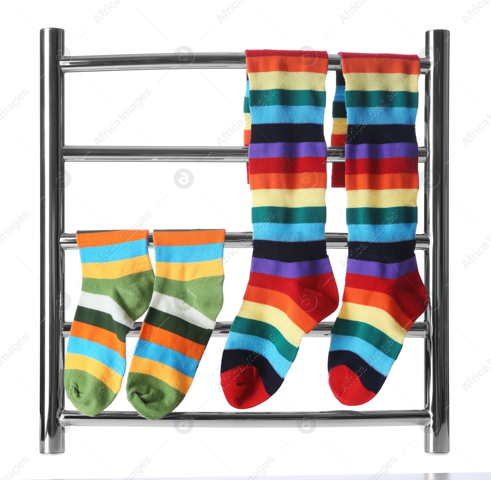 Photo of Modern heated towel rail with socks isolated on white