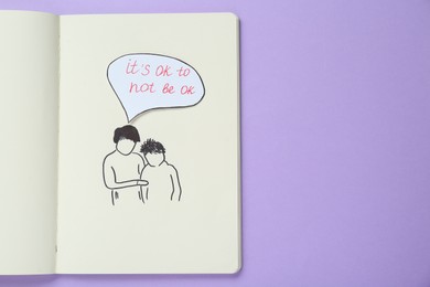 Card with phrase It`s Ok to Not Be Ok, drawing of mother and her son in notebook on violet background, top view. Space for text