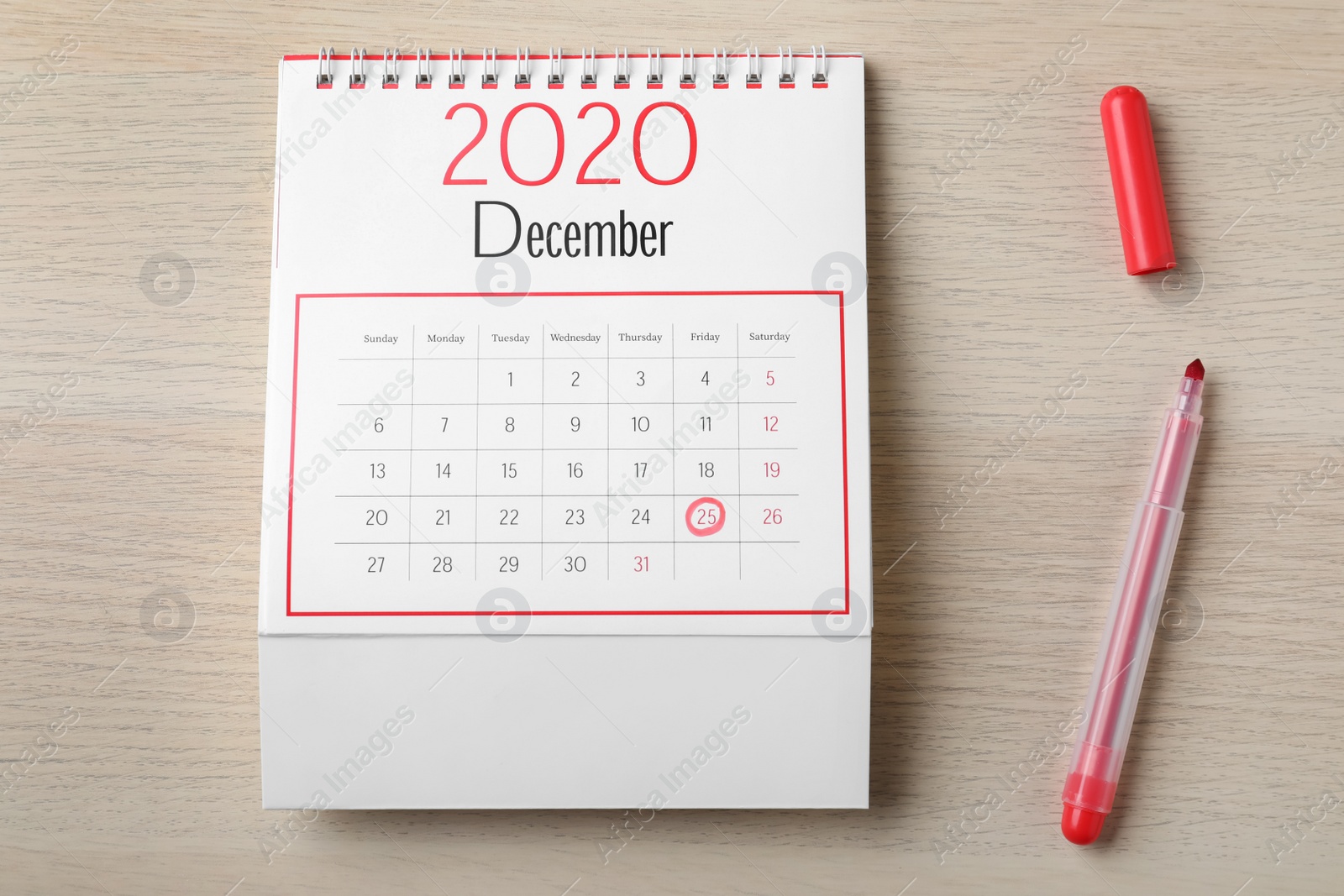 Photo of Calendar with marked date and red marker on wooden table, flat lay. Christmas countdown