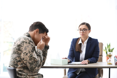 Photo of Psychotherapist working with male military officer in office