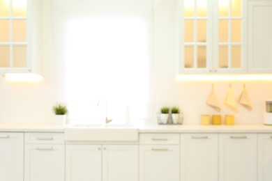 Photo of Blurred view of modern kitchen interior with stylish furniture