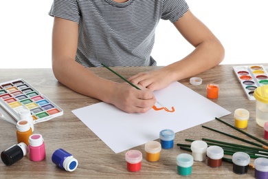 Photo of Cute child painting picture at table, closeup