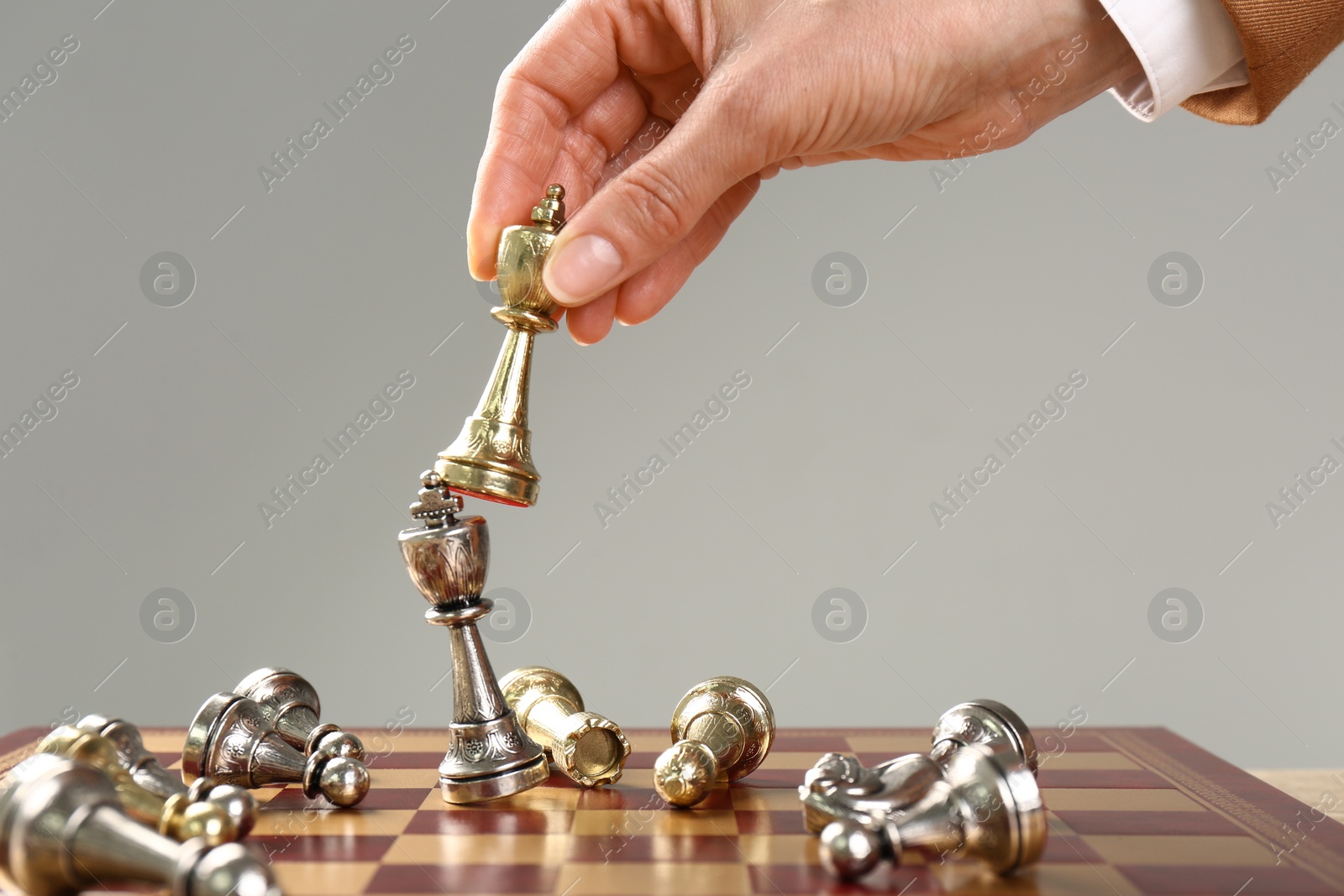 Photo of Woman moving chess piece on board, closeup