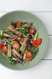 Delicious salad with beef tongue and vegetables on white wooden table, top view