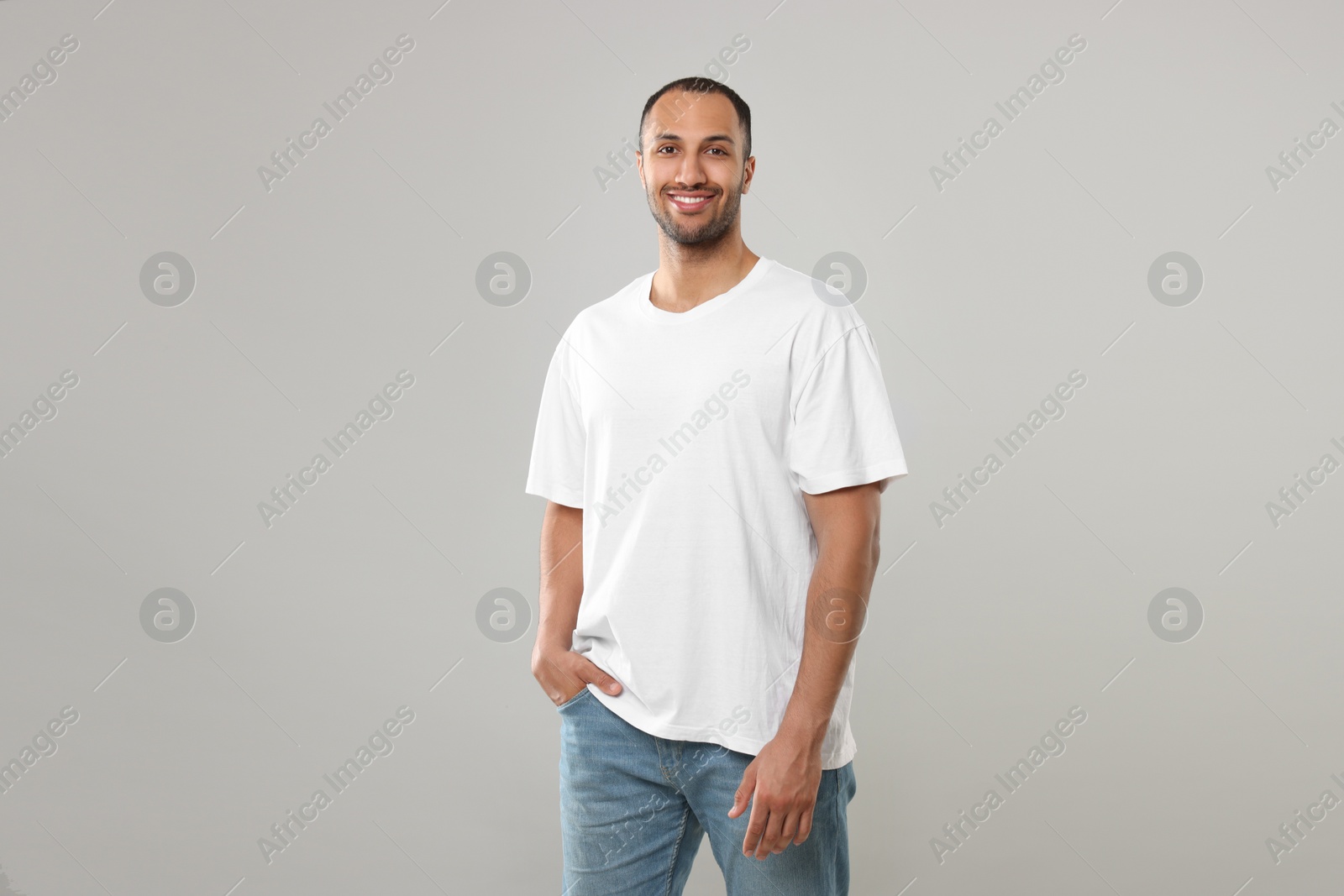 Photo of Man wearing white t-shirt on gray background