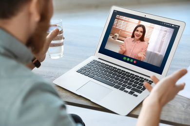 Image of Man having online meeting with his colleague via laptop, closeup