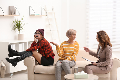 Photo of Woman complaining about difficult daughter in psychotherapist office