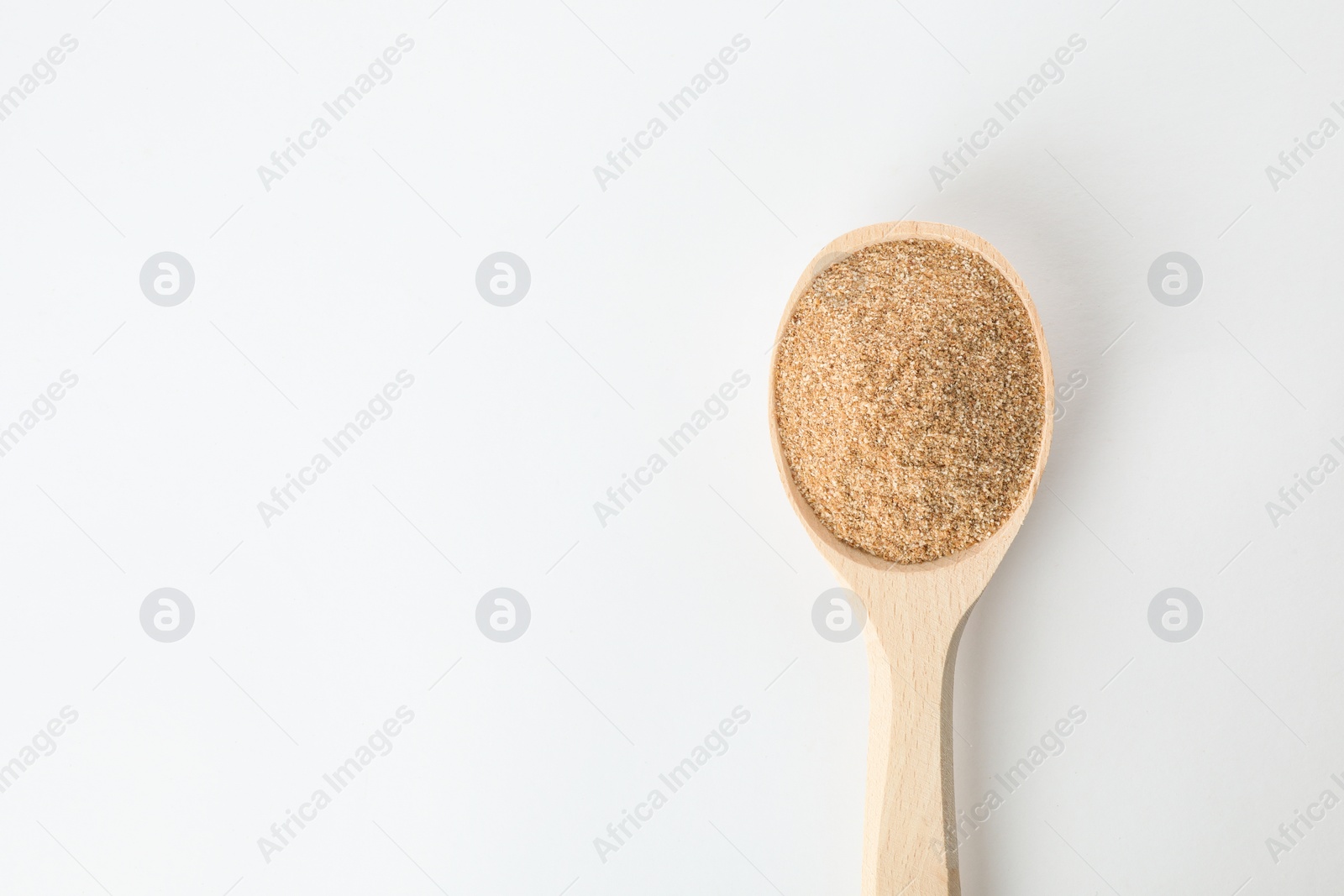 Photo of Spoon of buckwheat flour isolated on white, top view with space for text