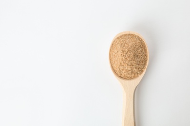 Spoon of buckwheat flour isolated on white, top view with space for text