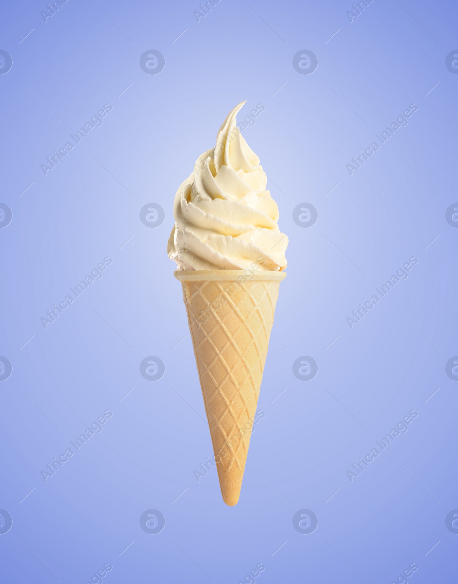 Image of Tasty vanilla ice cream in waffle cone on pastel blue background. Soft serve